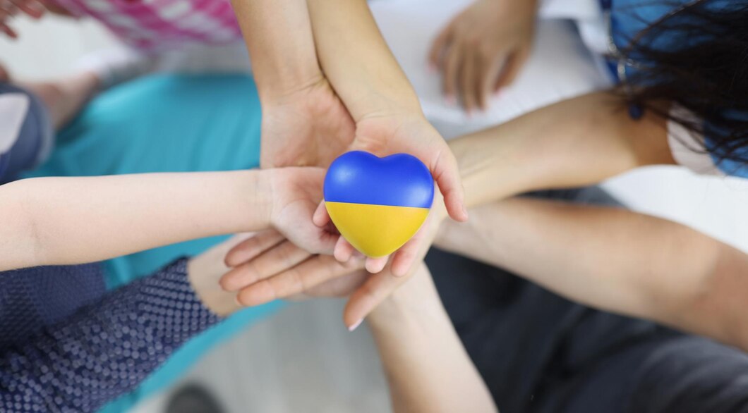 group-people-holding-hearts-with-flag-ukraine-their-hands-closeup-top-view_151013-37171